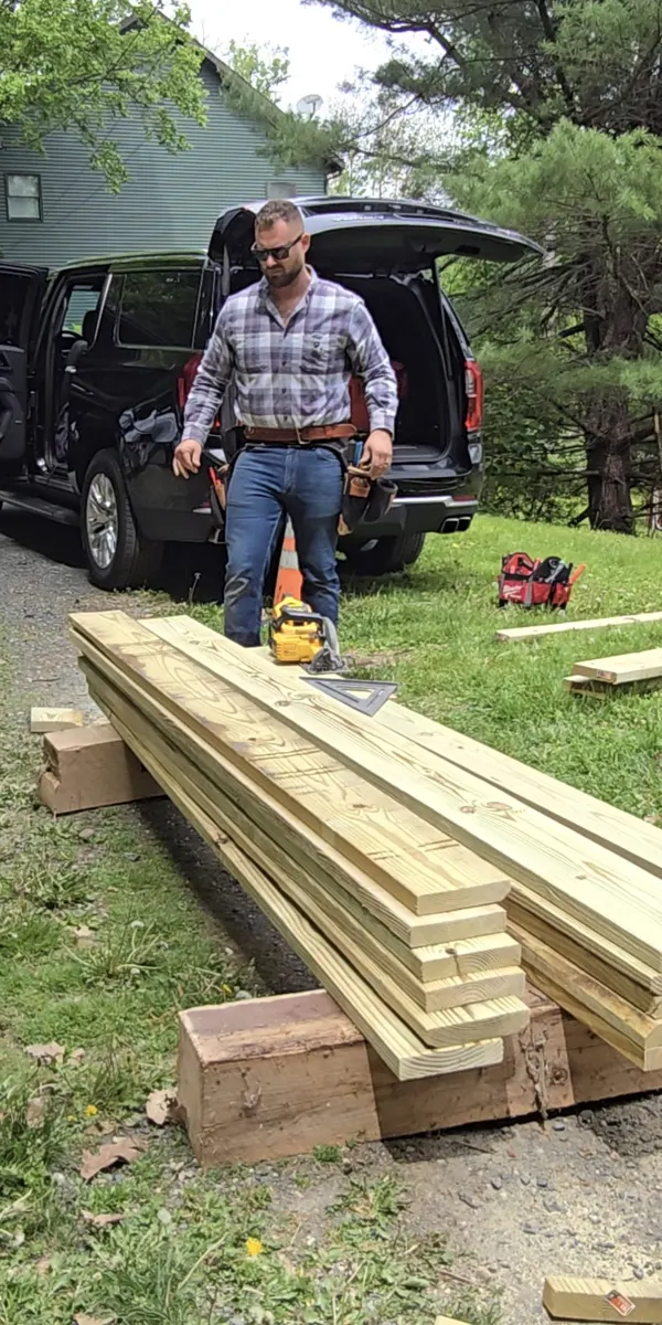 Matthew Pinto on site staging lumber for a build