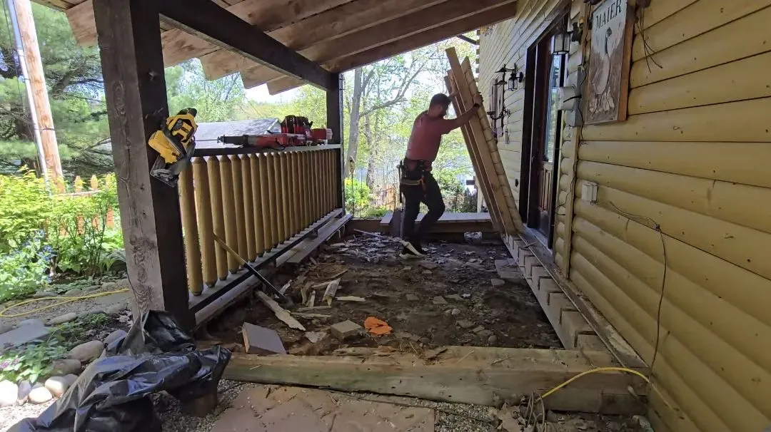 Full porch teardown in progress, structure opened to the framing